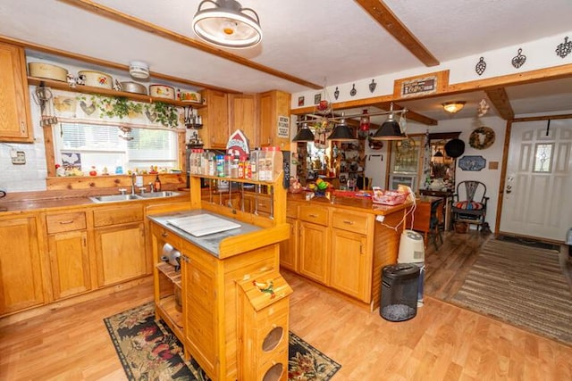 1213 Thomson Rd, Niles, MI 49120 - kitchen with open shelves, light wood-type flooring, butcher block countertops, beam ceiling, and a kitchen island