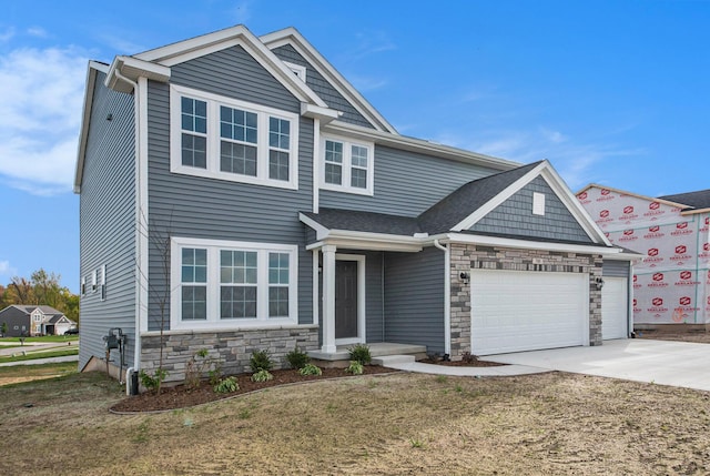 5589 Paxton Ct, Portage, MI 49024 - view of front of house featuring stone siding, an attached garage, driveway, and a front lawn