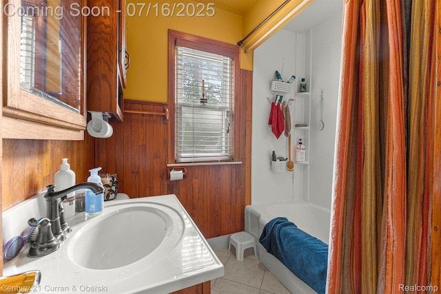 21280 Mada Ave, Southfield, MI 48075 - bathroom featuring tile patterned flooring, wood walls, wainscoting, vanity, and shower / tub combo
