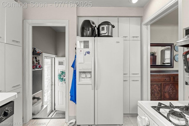21280 Mada Ave, Southfield, MI 48075 - kitchen with white appliances, white cabinets, light countertops, and light tile patterned floors