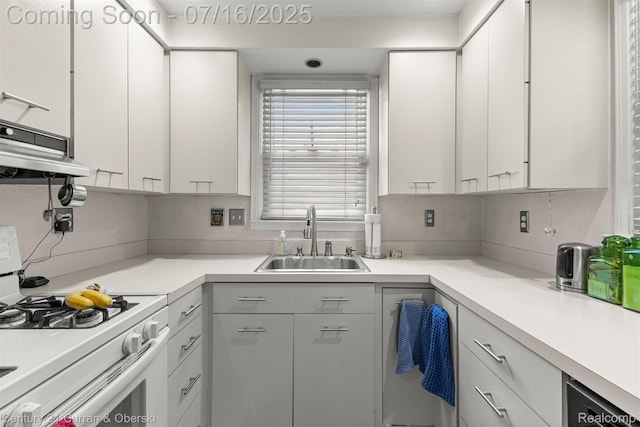 21280 Mada Ave, Southfield, MI 48075 - kitchen featuring white gas range oven, ventilation hood, light countertops, and white cabinetry