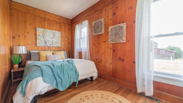 18216 S Schwark Rd, Three Oaks, MI 49128 - bedroom featuring wood walls and wood finished floors