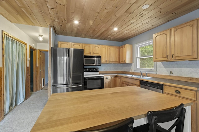4382 S Vandervoight, Traverse City, MI 49696 - kitchen with stainless steel appliances, butcher block counters, light colored carpet, recessed lighting, and light brown cabinetry