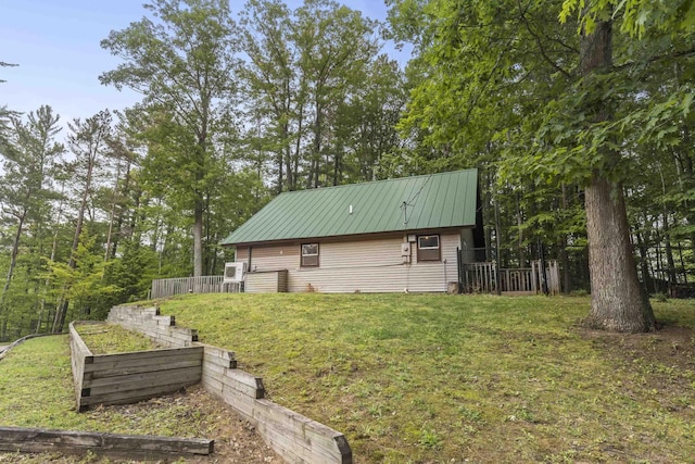 4382 S Vandervoight, Traverse City, MI 49696 - view of home's exterior with a garden and a metal roof