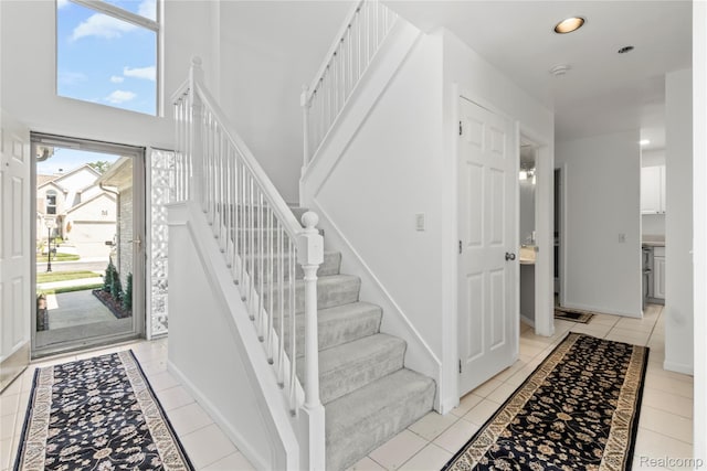 25893 Golf Pointe Dr, Southfield, MI 48075 - entrance foyer featuring light tile patterned floors, stairway, inlaid floor details, and recessed lighting