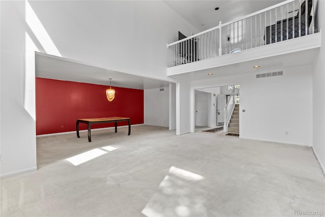 25893 Golf Pointe Dr, Southfield, MI 48075 - unfurnished living room with stairway, carpet, and a high ceiling