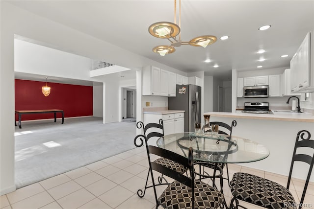 25893 Golf Pointe Dr, Southfield, MI 48075 - dining room with light carpet, recessed lighting, light tile patterned flooring, and a chandelier