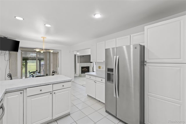 25893 Golf Pointe Dr, Southfield, MI 48075 - kitchen with stainless steel refrigerator with ice dispenser, light countertops, light tile patterned floors, white cabinets, and recessed lighting