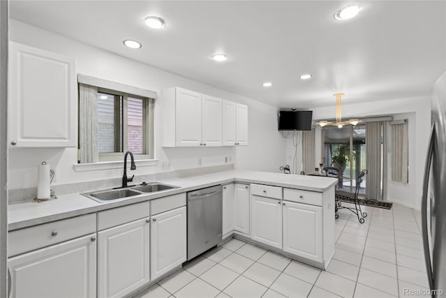 25893 Golf Pointe Dr, Southfield, MI 48075 - kitchen featuring stainless steel appliances, light countertops, a peninsula, white cabinetry, and light tile patterned floors