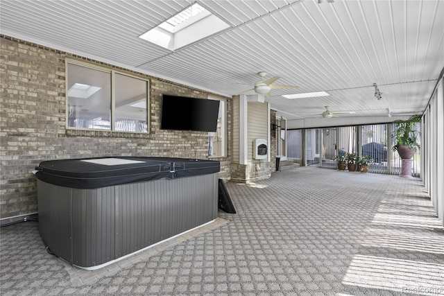 25893 Golf Pointe Dr, Southfield, MI 48075 - exterior space with carpet flooring, brick wall, track lighting, a ceiling fan, and a skylight