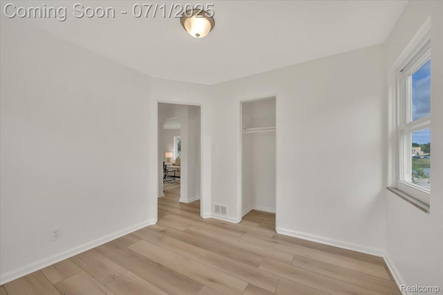 2190 Crescent Lake Rd, Holly, MI 48329 - unfurnished bedroom with light wood-type flooring and a closet