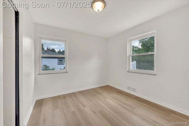 2190 Crescent Lake Rd, Holly, MI 48329 - empty room featuring light wood finished floors and plenty of natural light