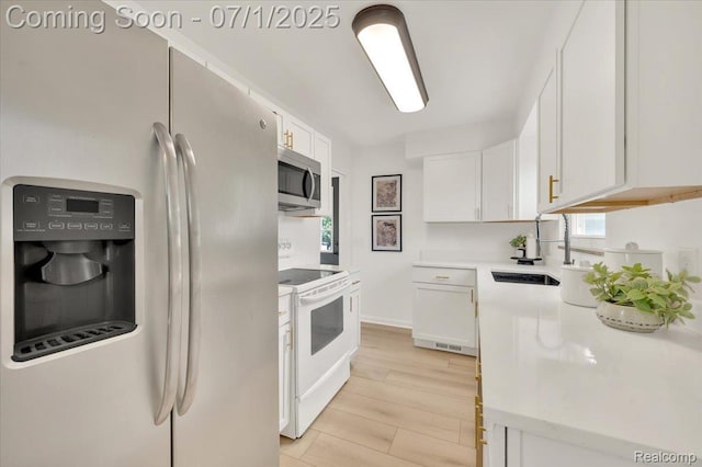 2190 Crescent Lake Rd, Holly, MI 48329 - kitchen with white appliances, white cabinetry, light countertops, and light wood-style flooring