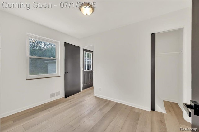 2190 Crescent Lake Rd, Holly, MI 48329 - unfurnished bedroom with light wood-style flooring and a closet