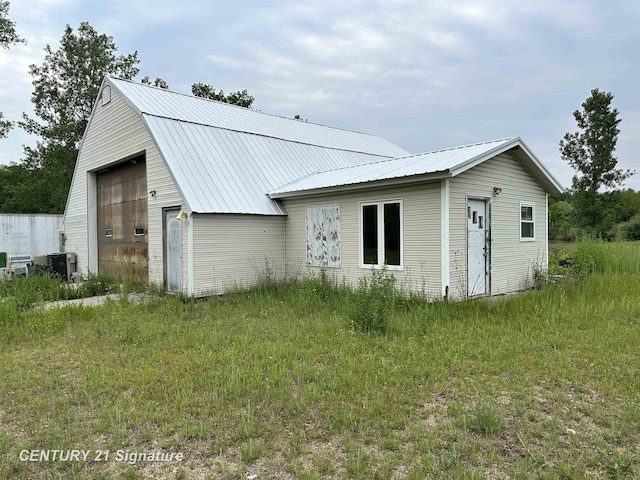 2252 N M-18 Rd, Beaverton, MI 48612 - view of property exterior with a metal roof and an outbuilding