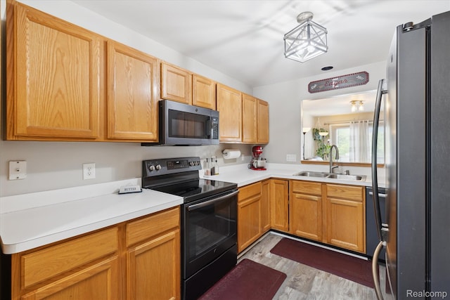 1484 Steeplechase Ct, Howell, MI 48843 - kitchen featuring appliances with stainless steel finishes, light countertops, and wood finished floors