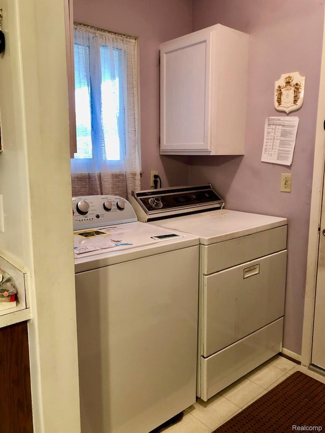 8681 Tucson Ct, Warren, MI 48093 - laundry room featuring washer and dryer, cabinet space, and light tile patterned floors