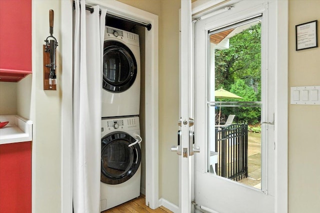 46210 Perkins Blvd, New Buffalo, MI 49117 - washroom featuring stacked washer and clothes dryer and light wood-style flooring