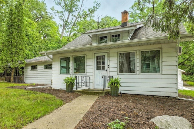 46210 Perkins Blvd, New Buffalo, MI 49117 - bungalow-style home featuring a chimney and a shingled roof