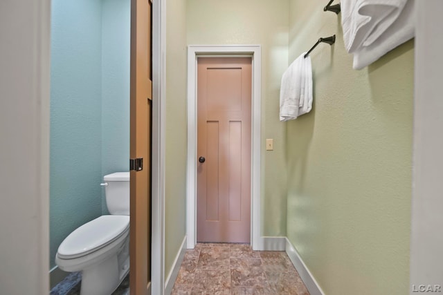 4078 Woodland Ave, Manitou Beach, MI 49253 - bathroom featuring baseboards and stone finish floors