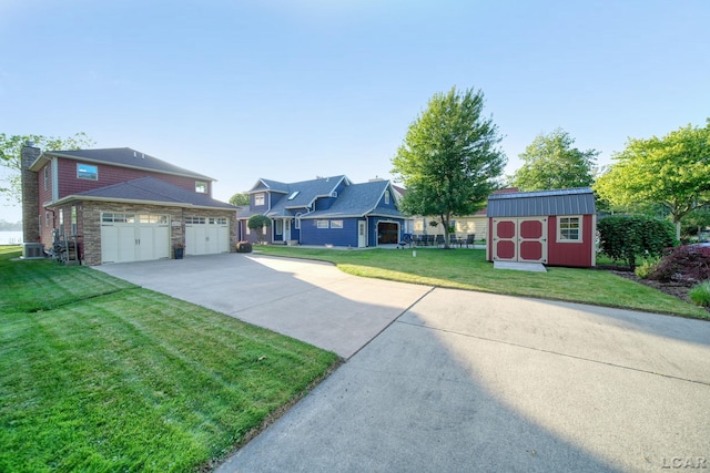 4078 Woodland Ave, Manitou Beach, MI 49253 - view of grassy yard with driveway, a shed, and a garage