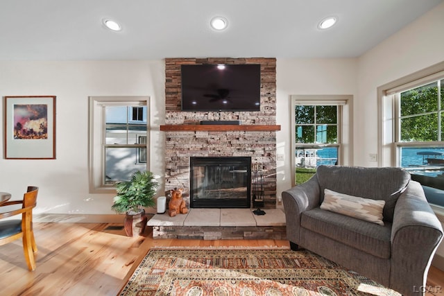 4078 Woodland Ave, Manitou Beach, MI 49253 - living area with wood finished floors, a fireplace, and recessed lighting