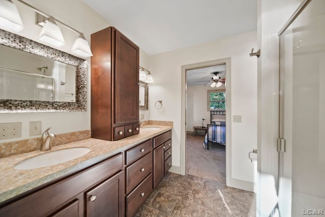 4078 Woodland Ave, Manitou Beach, MI 49253 - full bathroom featuring an enclosed shower, double vanity, ceiling fan, ensuite bathroom, and stone finish floors