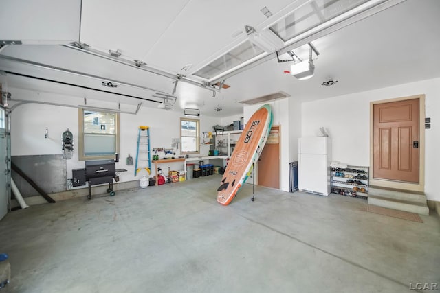 4078 Woodland Ave, Manitou Beach, MI 49253 - garage featuring freestanding refrigerator and a garage door opener