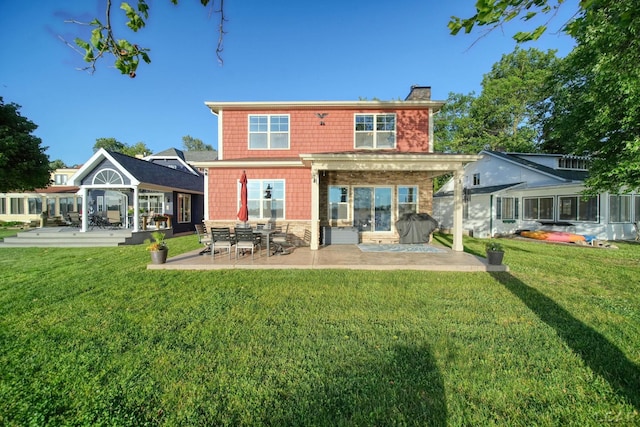 4078 Woodland Ave, Manitou Beach, MI 49253 - back of house with a chimney, a patio area, a lawn, and stone siding