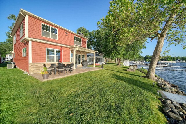 4078 Woodland Ave, Manitou Beach, MI 49253 - back of property with a patio area, a chimney, and a lawn