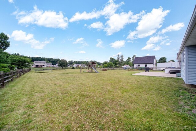 2099 Friar Tuck Cir, Adrian, MI 49221 - fenced backyard with a playground and a patio area