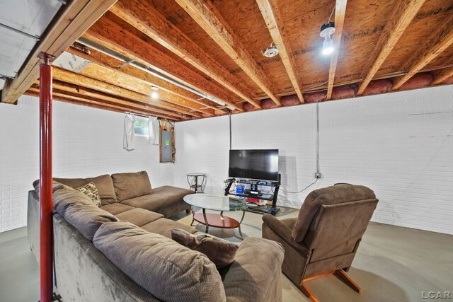 2099 Friar Tuck Cir, Adrian, MI 49221 - living area featuring finished concrete flooring and electric panel