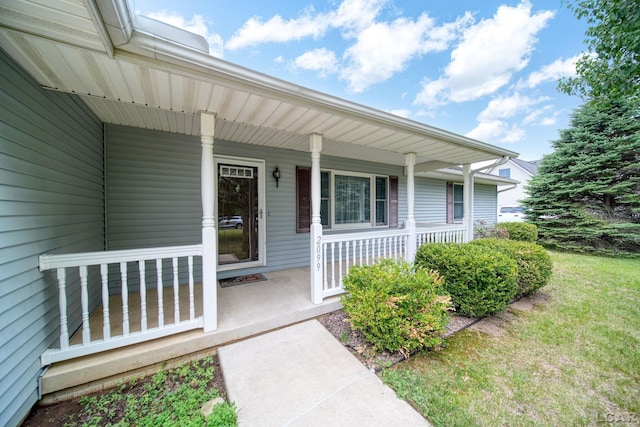 2099 Friar Tuck Cir, Adrian, MI 49221 - view of exterior entry with covered porch and a lawn