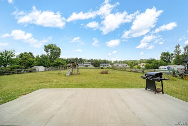 2099 Friar Tuck Cir, Adrian, MI 49221 - fenced backyard featuring a playground, a grill, and a patio area