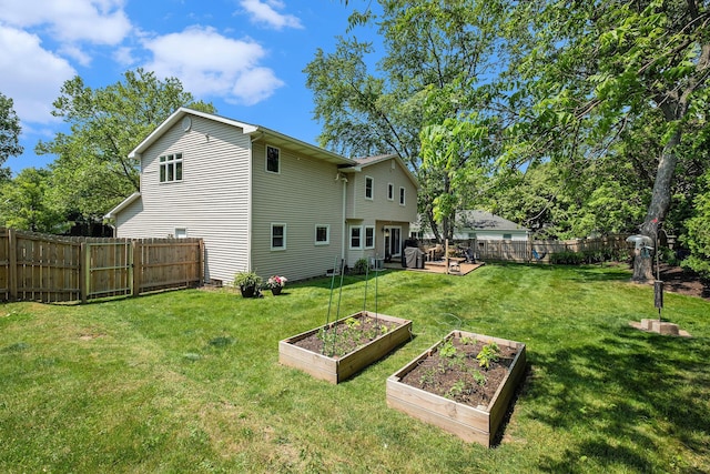 2211 Skyline Dr NW, Grand Rapids, MI 49504 - rear view of property featuring a vegetable garden and a fenced backyard