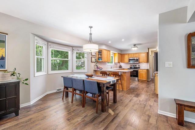 2211 Skyline Dr NW, Grand Rapids, MI 49504 - dining area featuring hardwood / wood-style floors, plenty of natural light, and recessed lighting