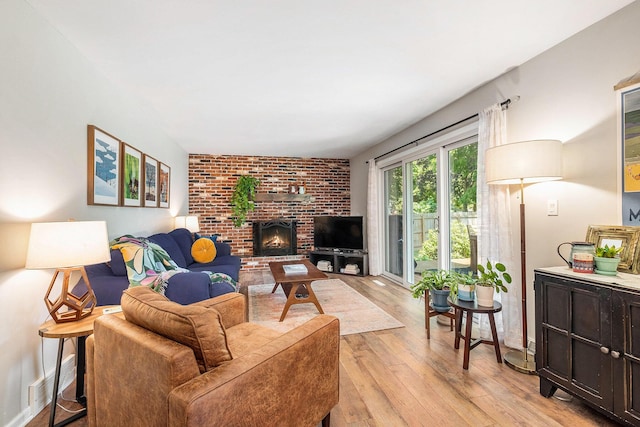 2211 Skyline Dr NW, Grand Rapids, MI 49504 - living area featuring light wood finished floors and a brick fireplace