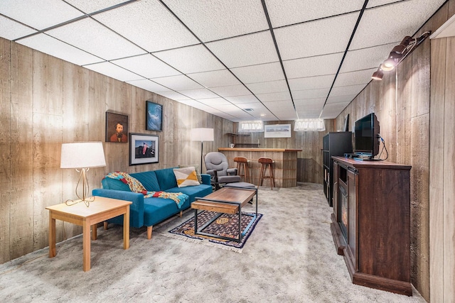 2211 Skyline Dr NW, Grand Rapids, MI 49504 - living room with a dry bar, wooden walls, a drop ceiling, and light colored carpet