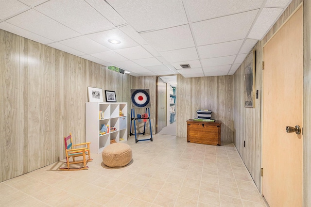 2211 Skyline Dr NW, Grand Rapids, MI 49504 - living area featuring wooden walls and a drop ceiling