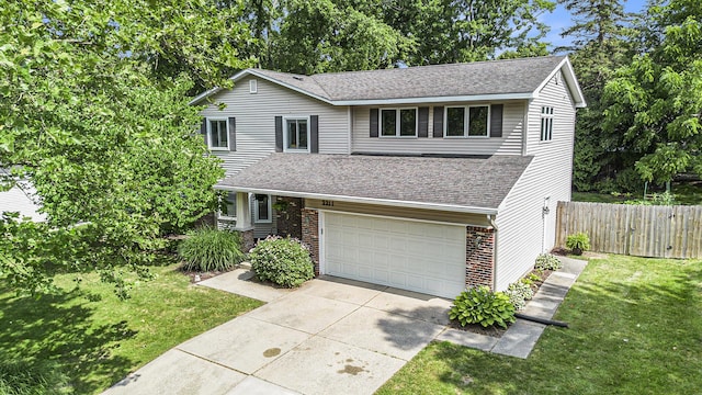 2211 Skyline Dr NW, Grand Rapids, MI 49504 - traditional home featuring concrete driveway, an attached garage, brick siding, and roof with shingles