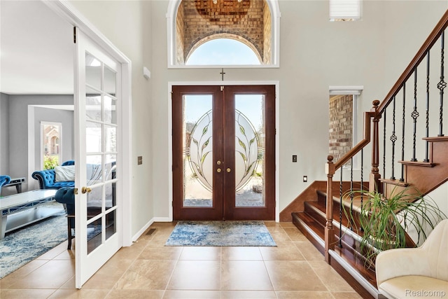 4303 S Lake Ln, Shelby Twp, MI 48316 - entrance foyer featuring french doors, a towering ceiling, stairs, and healthy amount of natural light