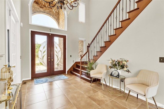 4303 S Lake Ln, Shelby Twp, MI 48316 - entrance foyer featuring stairs, french doors, a towering ceiling, a chandelier, and tile patterned flooring