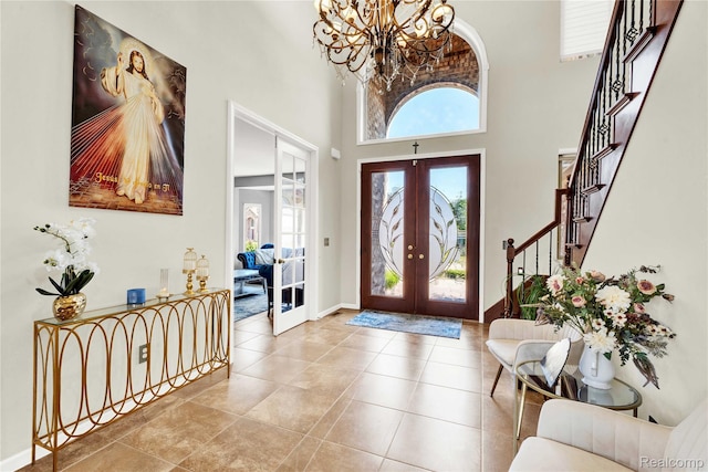 4303 S Lake Ln, Shelby Twp, MI 48316 - tiled foyer featuring french doors, a chandelier, stairs, and a towering ceiling