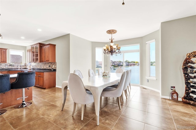 4303 S Lake Ln, Shelby Twp, MI 48316 - dining space featuring a chandelier, light tile patterned flooring, and recessed lighting