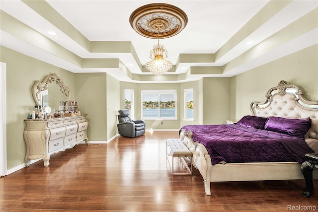 4303 S Lake Ln, Shelby Twp, MI 48316 - bedroom featuring a tray ceiling, a chandelier, and wood finished floors