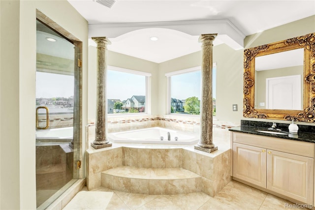 4303 S Lake Ln, Shelby Twp, MI 48316 - bathroom featuring decorative columns, vanity, a garden tub, and a shower stall