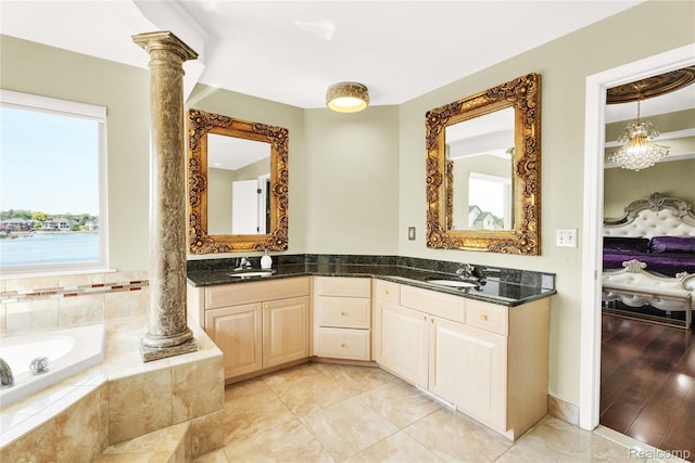 4303 S Lake Ln, Shelby Twp, MI 48316 - bathroom featuring ornate columns, double vanity, a bath, and tile patterned floors