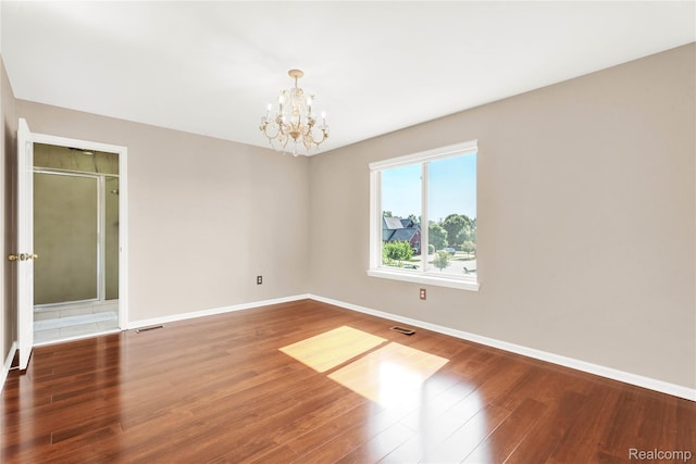 4303 S Lake Ln, Shelby Twp, MI 48316 - empty room with a chandelier and wood finished floors