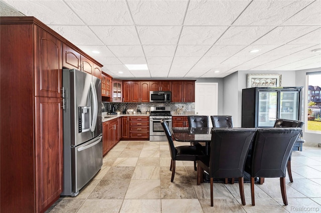 4303 S Lake Ln, Shelby Twp, MI 48316 - kitchen with appliances with stainless steel finishes, light countertops, glass insert cabinets, tasteful backsplash, and recessed lighting