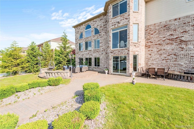 4303 S Lake Ln, Shelby Twp, MI 48316 - rear view of property featuring an outdoor hangout area, a patio, and a lawn